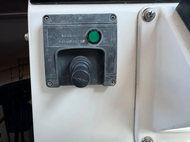 Slide: The Image of Control panel of a 2005 Albin 28 Tournament Express boat with a green button. - 18