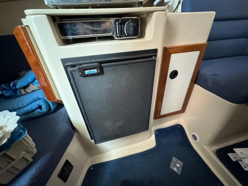 Slide: The Image of Interior of a 2005 Albin 28 Tournament Express boat with a compact fridge. - 27