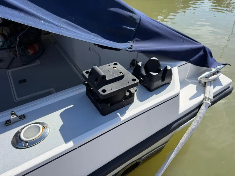 Slide: The Image of 2005 Albin 28 Tournament Express boat with blue cover and docked in water. - 29