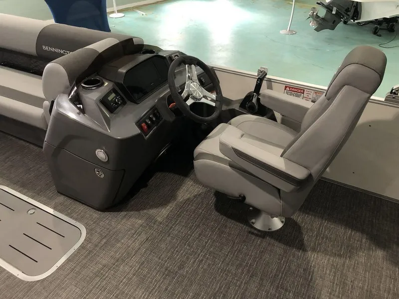 Slide: The Image of 2025 Bennington S Swingback 22 SSB boat interior with steering console and captain's chair. - 4