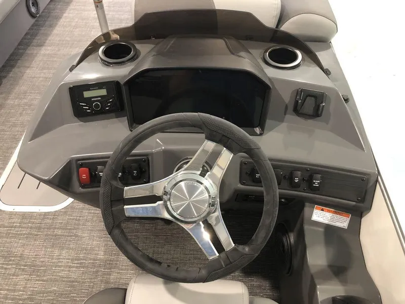 Slide: The Image of 2025 Bennington S Swingback 22 SSB dashboard with steering wheel and controls. - 6