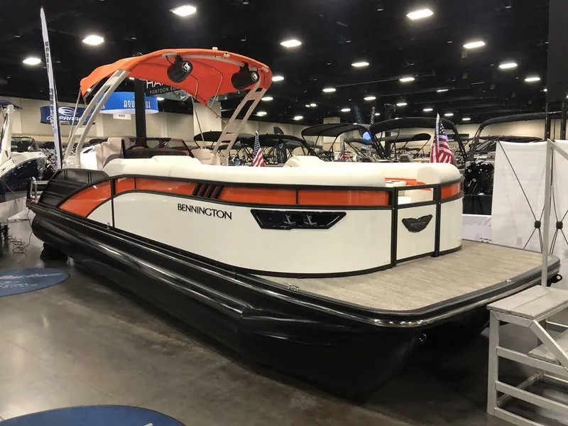 The Image of 2024 Bennington LX Sport Swingback 26 LXSSBA pontoon boat displayed indoors. - 1