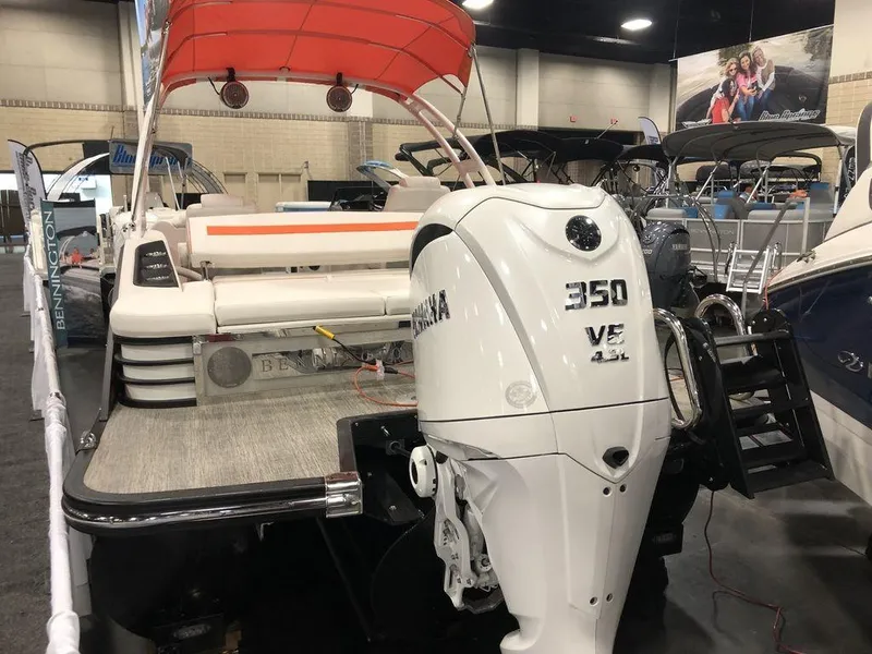 Slide: The Image of 2024 Bennington LX Sport Swingback 26 LXSSBA with Yamaha 350 V8 engine at a boat show. - 7
