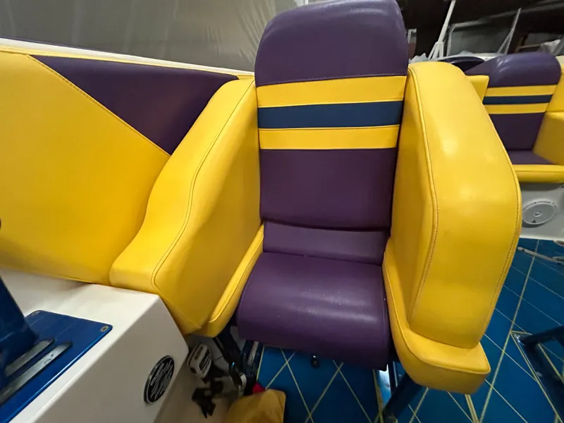 Slide: The Image of 2000 Active Thunder 370 Excess boat seat with vibrant yellow and purple upholstery. - 10
