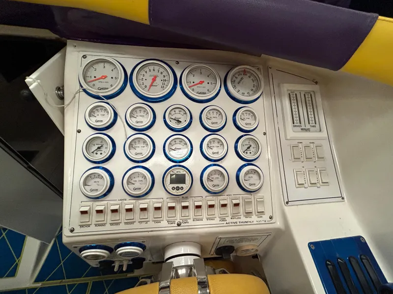 Slide: The Image of Control panel of a 2000 Active Thunder 370 Excess boat with multiple gauges and switches. - 11