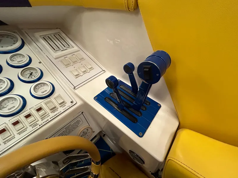 Slide: The Image of Control panel of 2000 Active Thunder 370 Excess boat with gauges and throttle levers. - 13