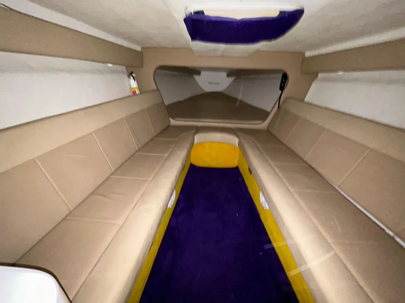 Slide: The Image of Interior of 2000 Active Thunder 370 Excess boat with beige seating and purple carpet. - 14