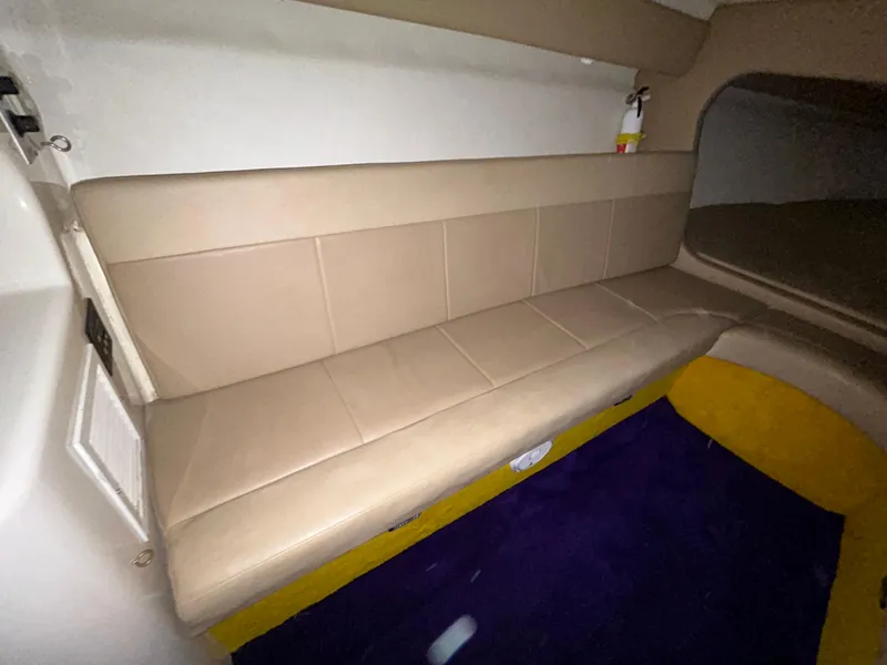 Slide: The Image of Interior seating of 2000 Active Thunder 370 Excess boat, featuring beige upholstery. - 15