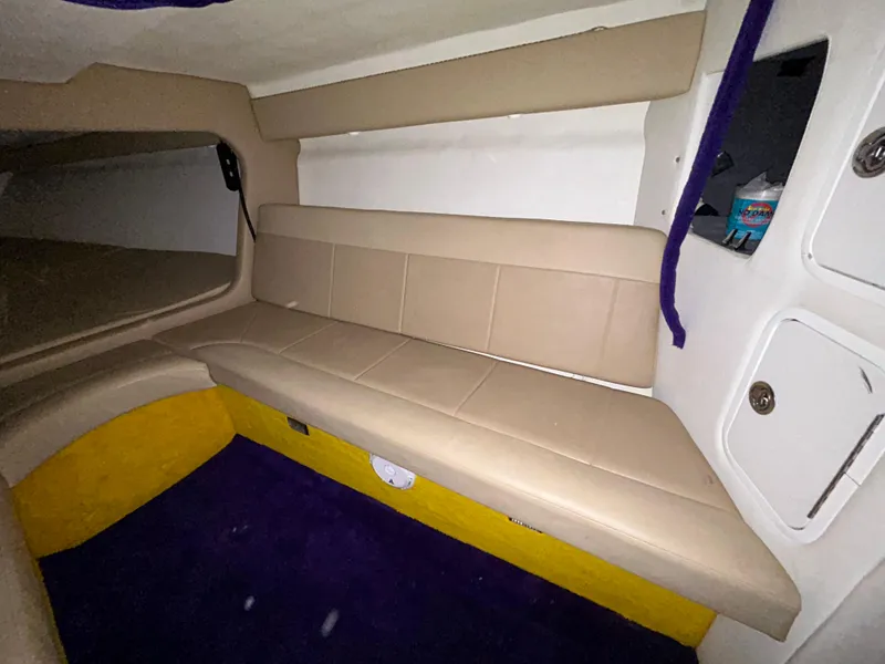 Slide: The Image of Interior of 2000 Active Thunder 370 Excess boat with beige seating and storage compartments. - 16