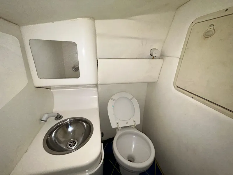 Slide: The Image of Bathroom interior of 2000 Active Thunder 370 Excess boat, featuring sink and toilet. - 18
