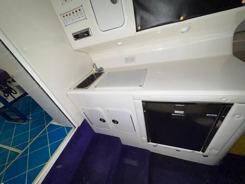 Slide: The Image of Interior of 2000 Active Thunder 370 Excess boat with kitchenette and storage. - 19