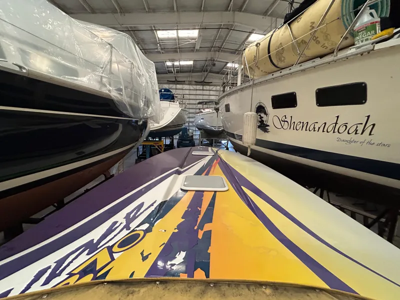 Slide: The Image of 2000 Active Thunder 370 Excess boat in storage, surrounded by other vessels. - 20