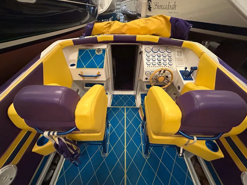 Slide: The Image of Interior of a 2000 Active Thunder 370 Excess boat with vibrant yellow and purple seating. - 4