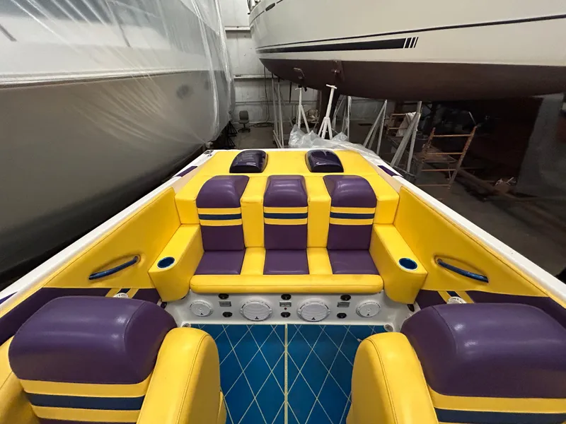 Slide: The Image of 2000 Active Thunder 370 Excess boat interior with vibrant yellow and purple seating. - 5