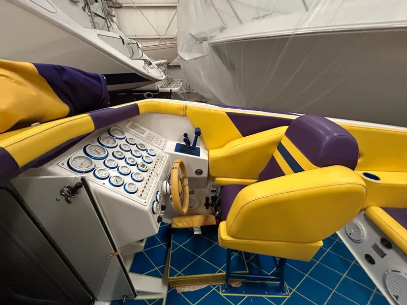 Slide: The Image of Interior of a 2000 Active Thunder 370 Excess boat with vibrant yellow and purple seating. - 6