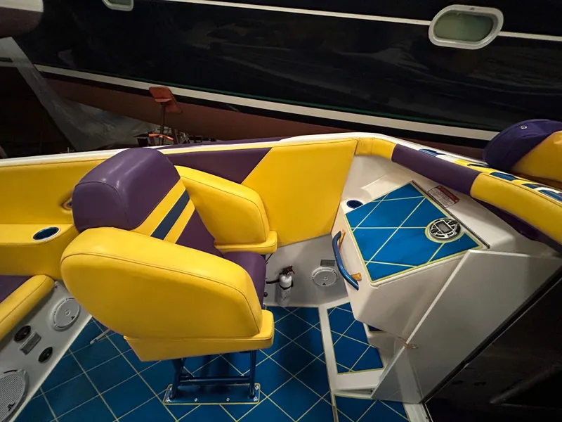 Slide: The Image of Interior of 2000 Active Thunder 370 Excess boat with vibrant yellow and purple seating. - 7