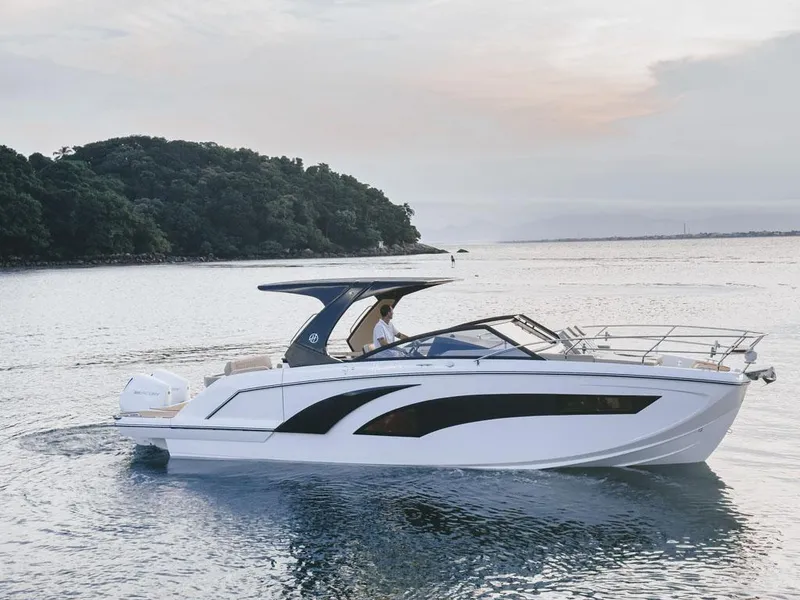 The Image of 2024 Hanover 347 boat cruising on serene waters near a lush island. - 0