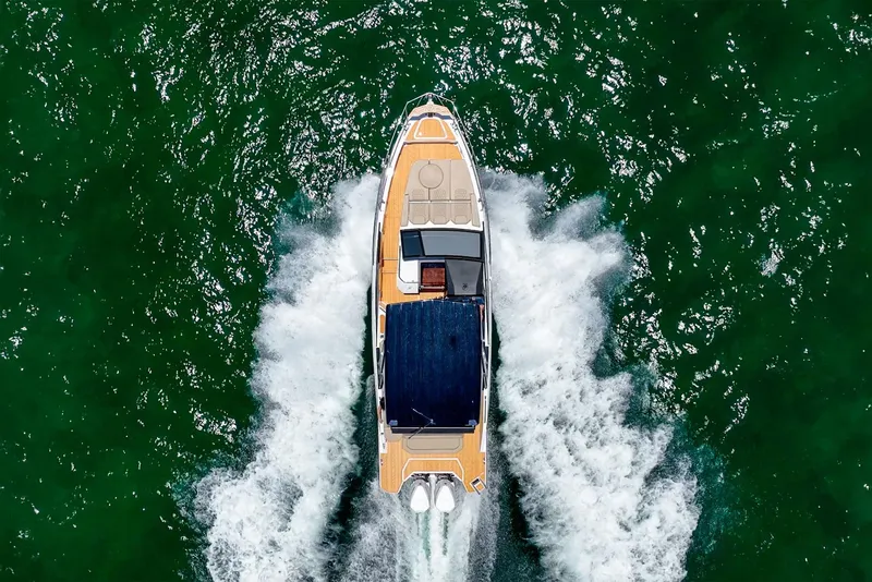 Slide: The Image of Aerial view of 2024 Hanover 347 boat cruising on green water. - 11