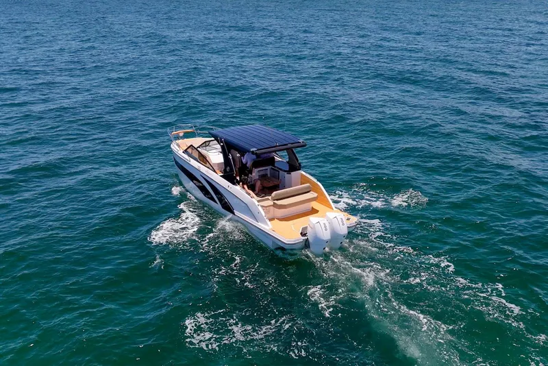 Slide: The Image of 2024 Hanover 347 boat cruising on open water, showcasing sleek design and powerful engines. - 12