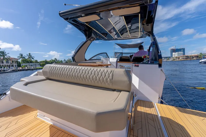Slide: The Image of 2024 Hanover 347 yacht with luxurious seating and scenic waterfront view. - 16