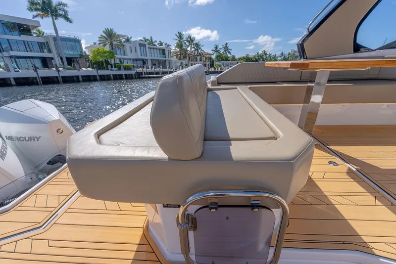 Slide: The Image of 2024 Hanover 347 boat with beige seating, wooden deck, and waterfront view. - 17