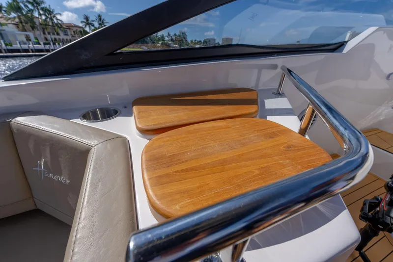 Slide: The Image of Luxurious seating on 2024 Hanover 347 boat with wooden accents and sleek design. - 24