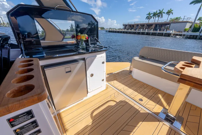 Slide: The Image of Luxurious 2024 Hanover 347 yacht interior with sleek kitchen and seating area by the water. - 27
