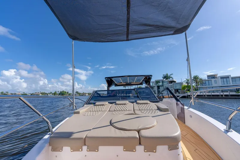 Slide: The Image of 2024 Hanover 347 boat with sunshade, cruising on a sunny day by waterfront homes. - 33