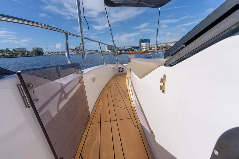 Slide: The Image of 2024 Hanover 347 yacht deck with wooden flooring, overlooking a scenic waterfront. - 38