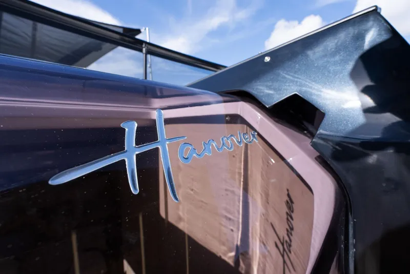 Slide: The Image of 2024 Hanover 347 boat with sleek design and reflective surface under blue sky. - 39