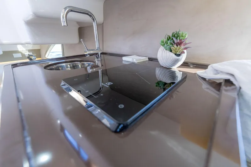 Slide: The Image of Modern kitchen area in 2024 Hanover 347 yacht with sleek cooktop and sink. - 46