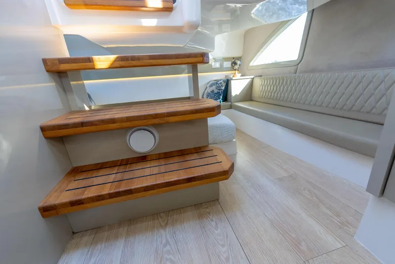 Slide: The Image of Interior of 2024 Hanover 347 yacht with wooden steps and modern seating area. - 48