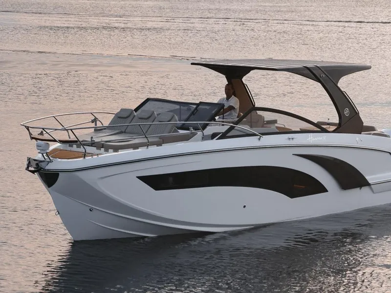 Slide: The Image of 2024 Hanover 347 boat cruising on calm water at sunset. - 6