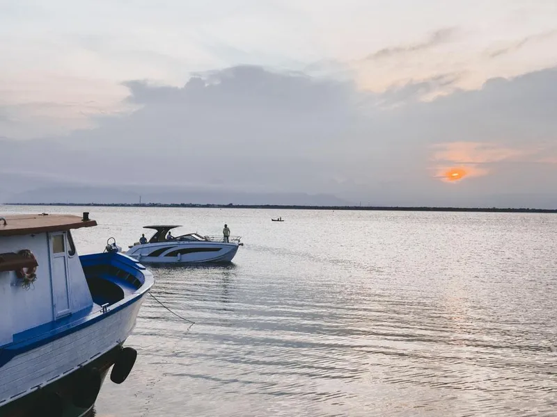 Slide: The Image of Boats on a calm lake at sunset, featuring a Hanover 347 model, 2024. - 7