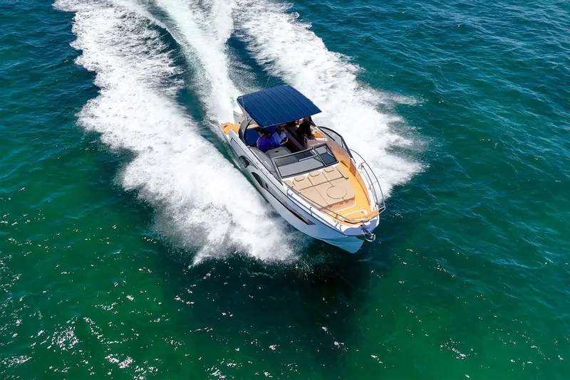 Slide: The Image of 2024 Hanover 347 boat cruising on clear blue water, top view. - 9