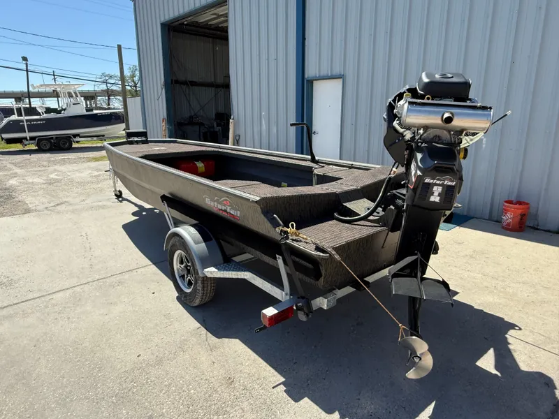 Slide: The Image of 2025 Gator Tail 1854 Extreme boat on trailer outside a warehouse. - 5