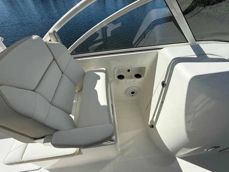 Slide: The Image of 2025 World Cat 296 DC boat interior with white seating and cup holders. - 15