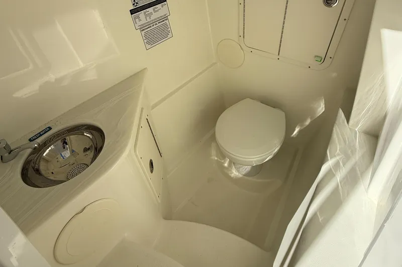 Slide: The Image of 2025 World Cat 296 DC boat interior bathroom with sink and toilet. - 16