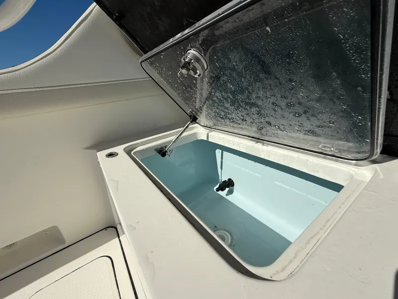 Slide: The Image of Open storage compartment on 2025 World Cat 296 DC boat. - 9