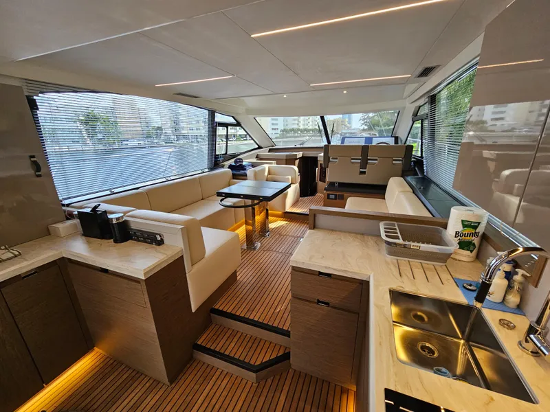 Slide: The Image of Luxurious interior of 2021 Beneteau Monte Carlo 52 yacht with modern kitchen and seating area. - 13