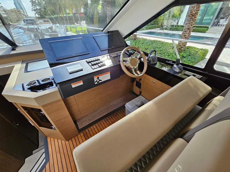 Slide: The Image of 2021 Beneteau Monte Carlo 52 helm station with modern controls and luxurious seating. - 15