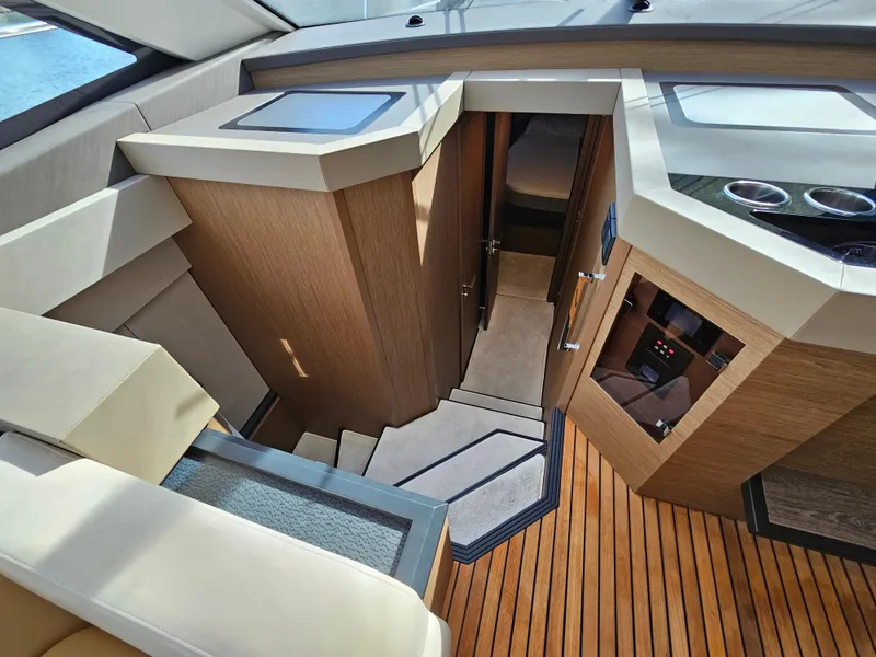 Slide: The Image of Interior view of 2021 Beneteau Monte Carlo 52 yacht, featuring elegant wood finishes and modern design. - 16