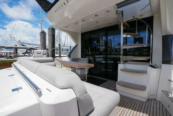 Slide: The Image of 2021 Beneteau Monte Carlo 52 yacht deck with seating and spiral staircase. - 6
