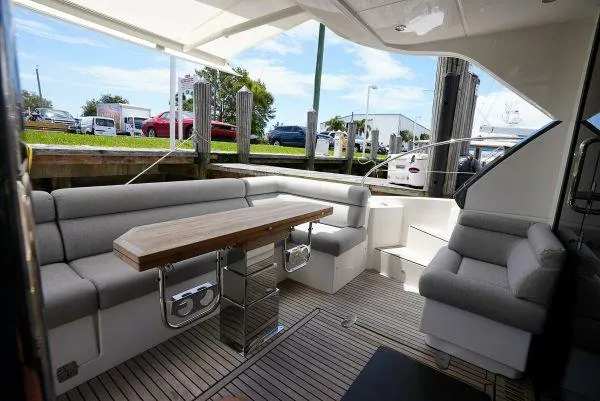 Slide: The Image of Luxurious seating area on 2021 Beneteau Monte Carlo 52 yacht with wooden table. - 7