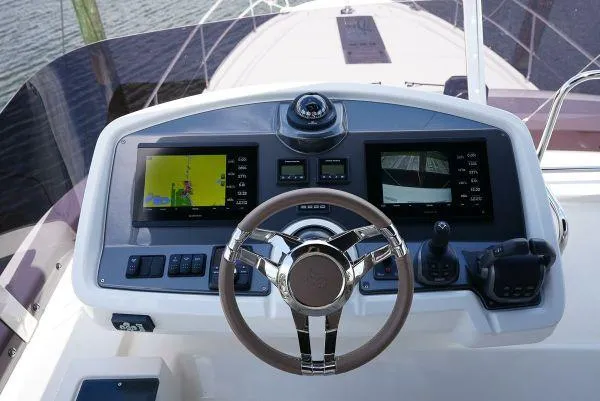 Slide: The Image of Helm of 2021 Beneteau Monte Carlo 52 with modern navigation displays and controls. - 8
