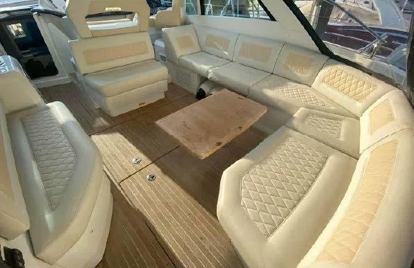 Slide: The Image of 2019 Beneteau Gran Turismo 40 interior with beige leather seating and wooden flooring. - 19