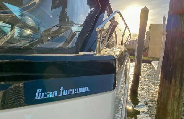 Slide: The Image of 2019 Beneteau Gran Turismo 40 yacht docked at sunset, reflecting on water. - 24