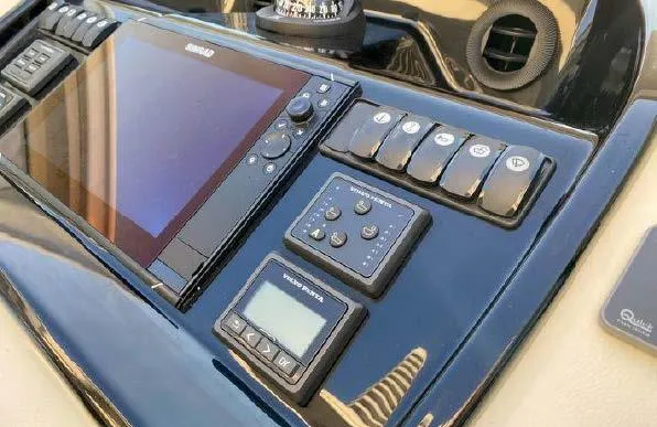 Slide: The Image of Control panel of 2019 Beneteau Gran Turismo 40 yacht with navigation display and switches. - 38
