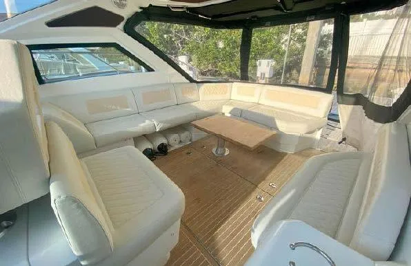 Slide: The Image of 2019 Beneteau Gran Turismo 40 interior with spacious seating and wooden table. - 41