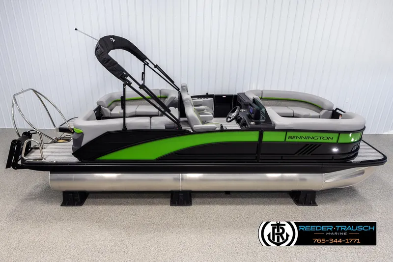 Slide: The Image of 2025 Bennington MFBSE pontoon boat with green and black design, displayed indoors. - 1